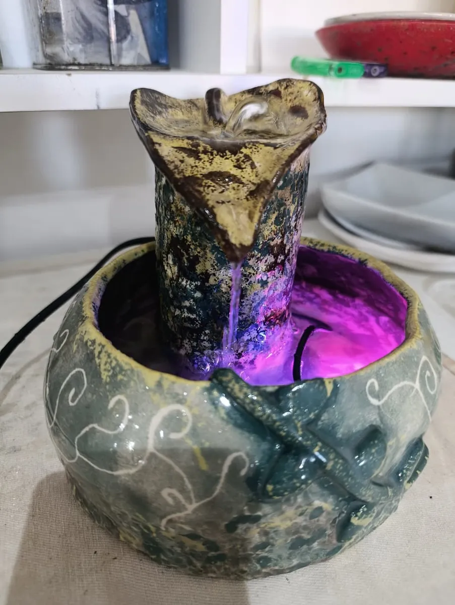 Fuente de cerámica esmaltada, con luz magenta en el interior